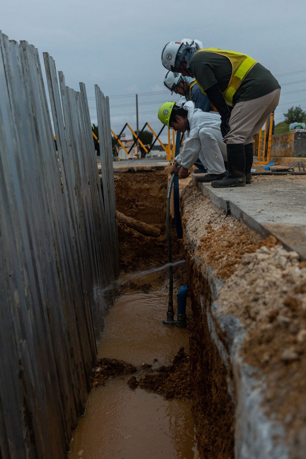 MWSS-172 heavy equipment operators assist in the repair of burst pipe