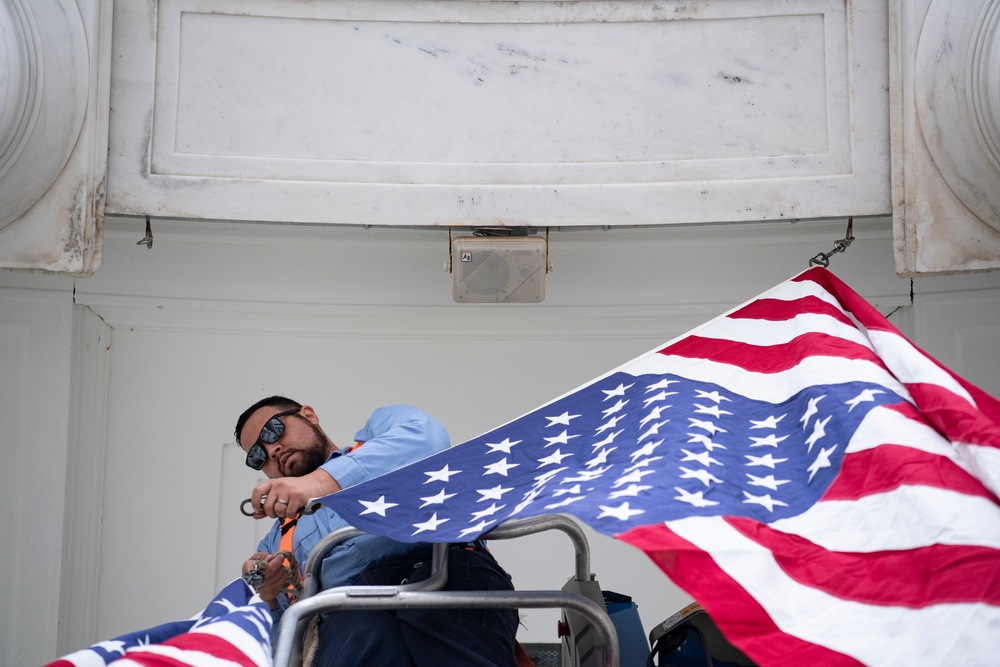 U.S. Flags are Hung in the Memorial Amphitheater in Preparation for the National Memorial Day Observance