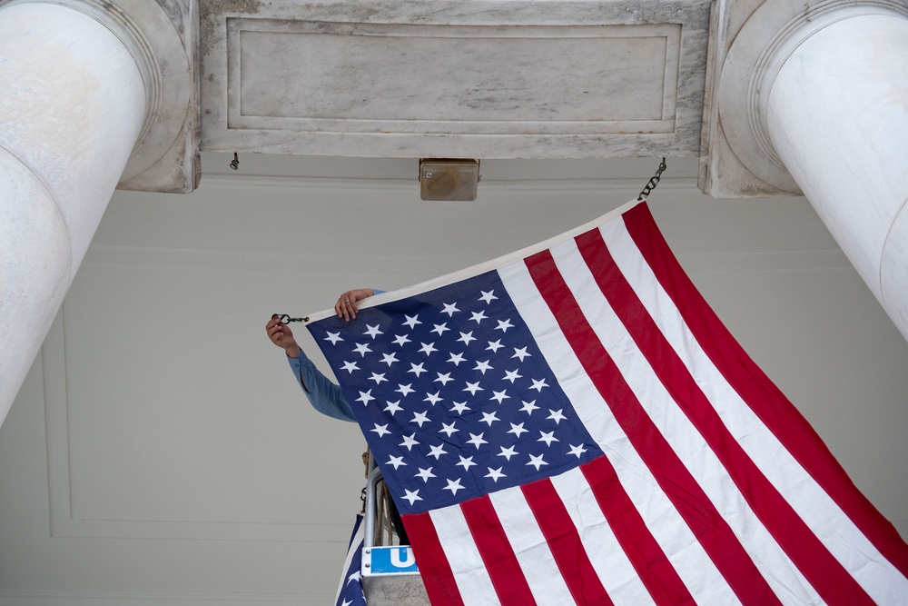 U.S. Flags are Hung in the Memorial Amphitheater in Preparation for the National Memorial Day Observance