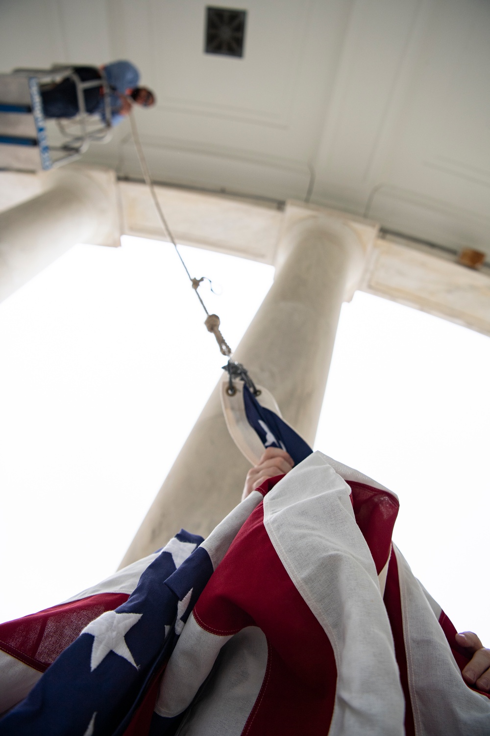 U.S. Flags are Hung in the Memorial Amphitheater in Preparation for the National Memorial Day Observance