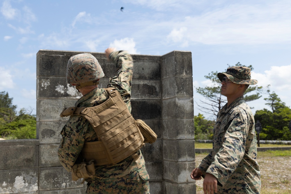 Marines with 3rd Intelligence Battalion throw grenades during a field exercise.