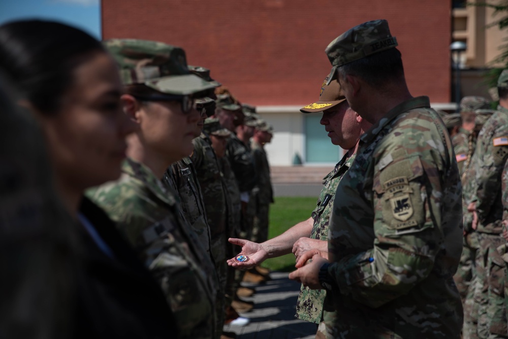 Vice Adm. Thomas Ishee presents coins to members of SETAF-AF