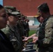 Vice Adm. Thomas Ishee presents coins to members of SETAF-AF