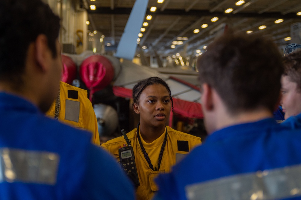 USS Ronald Reagan (CVN 76) Sailors move aircraft in hangar bay