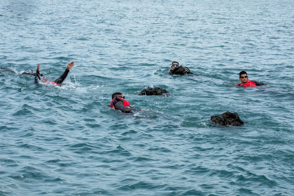 Competitors take part in Fuerzas Comando 24 Aquatic Run-and-Shoot Event