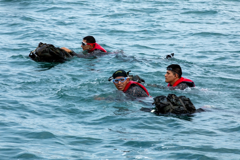 Competitors take part in Fuerzas Comando 24 Aquatic Run-and-Shoot Event