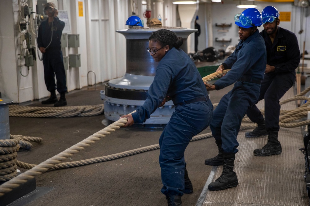 Sailors heave lines aboard USS Tripoli