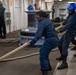 Sailors heave lines aboard USS Tripoli