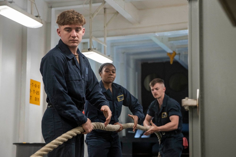 Sailors heave lines aboard USS Tripoli