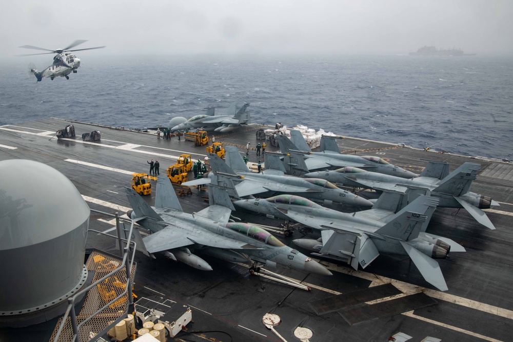 USS Ronald Reagan (CVN 76) conducts a replenishment-at-sea and a fueling-at-sea with USNS Charles Drew and USNS John Ericsson