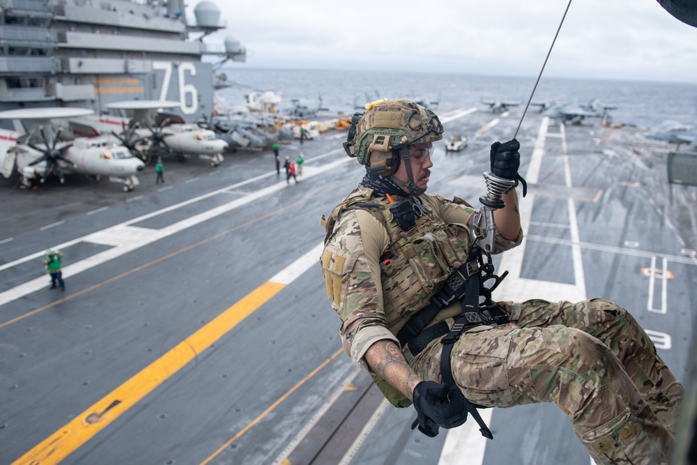 Members of EODMU 5 conduct a hoisting and rappelling exercise aboard  USS Ronald Reagan (CVN 76)