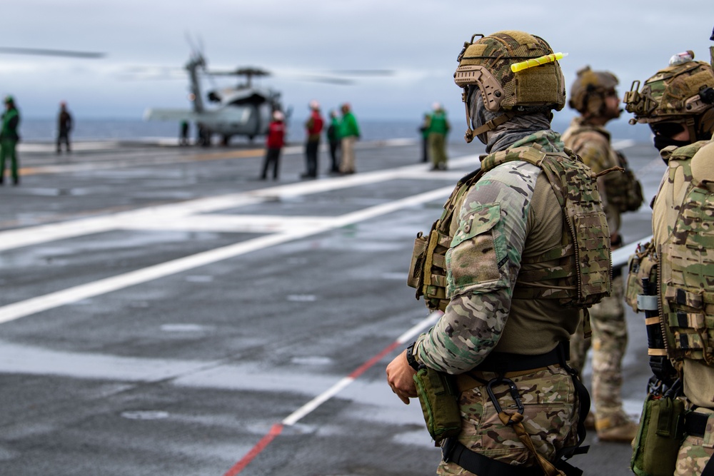 Members of EODMU 5 conduct a hoisting and rappelling exercise aboard USS Ronald Reagan (CVN 76)