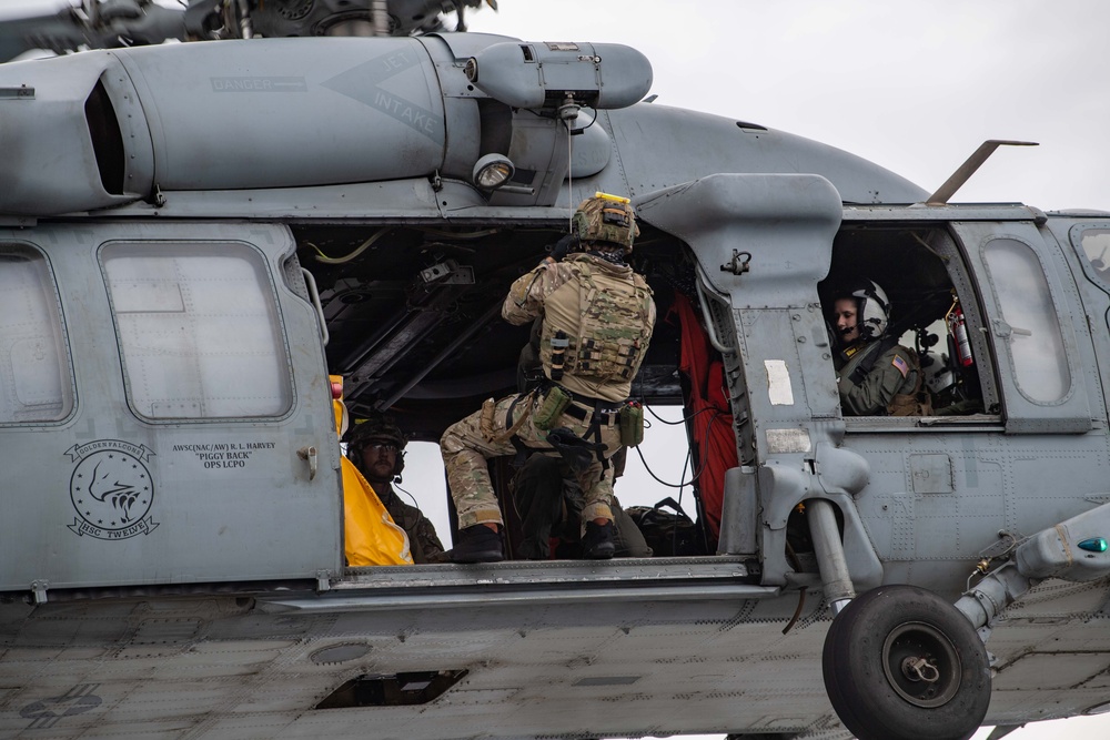 Members of EODMU 5 conduct a hoisting and rappelling exercise aboard USS Ronald Reagan (CVN 76)