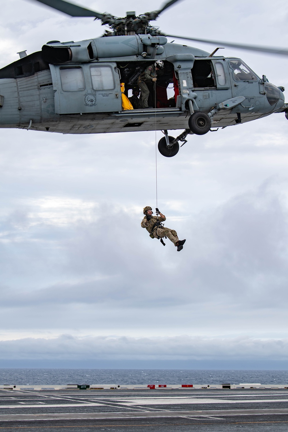 Members of EODMU 5 conduct a hoisting and rappelling exercise aboard USS Ronald Reagan (CVN 76)