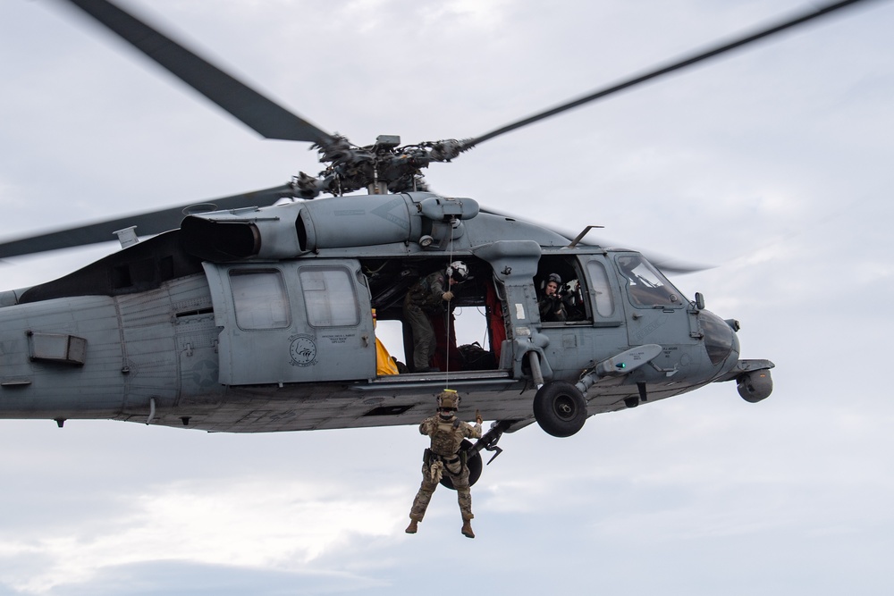 Members of EODMU 5 conduct a hoisting and rappelling exercise aboard USS Ronald Reagan (CVN 76)