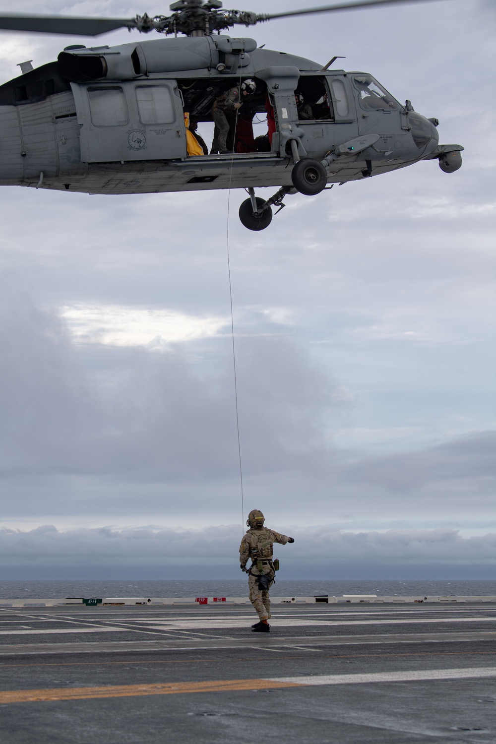 Members of EODMU 5 conduct a hoisting and rappelling exercise aboard USS Ronald Reagan (CVN 76)