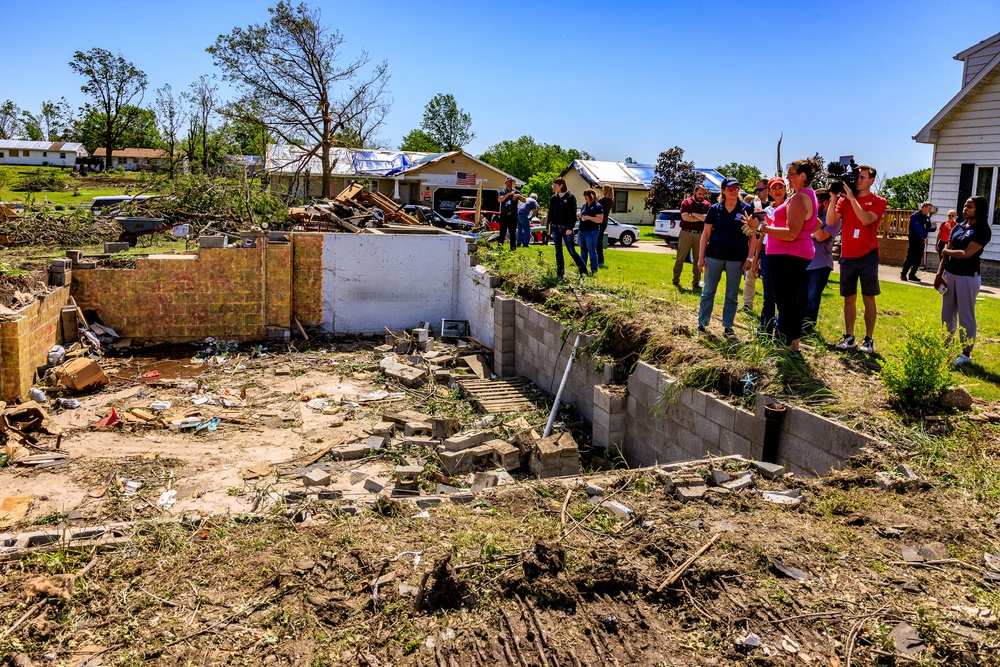 Federal and State Officials Walk around an Iowa Neighborhood Damaged by a Tornado