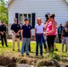 Federal and State Officials Walk around an Iowa Neighborhood Damaged by a Tornado