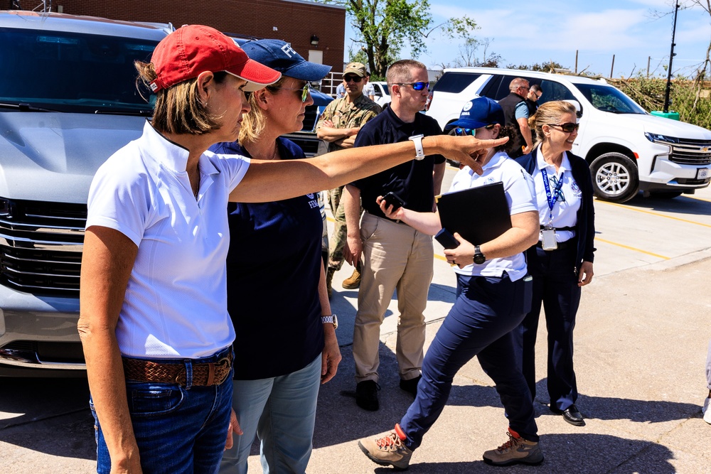 Federal and State Officials Walk around an Iowa Neighborhood Damaged by a Tornado
