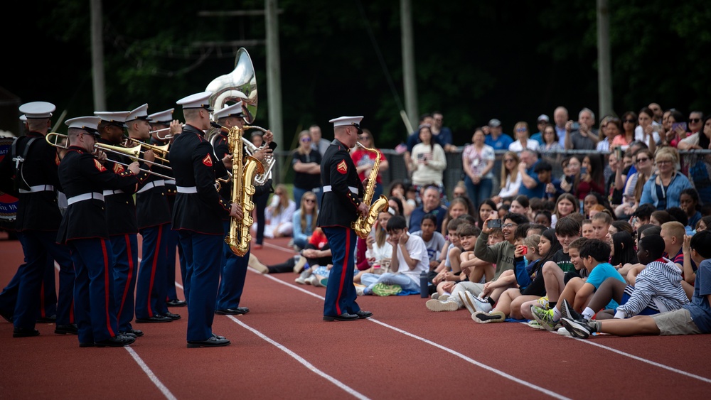 U.S. Marines with the Silent Drill Platoon and the Quantico Band interact with the students of Elwood.