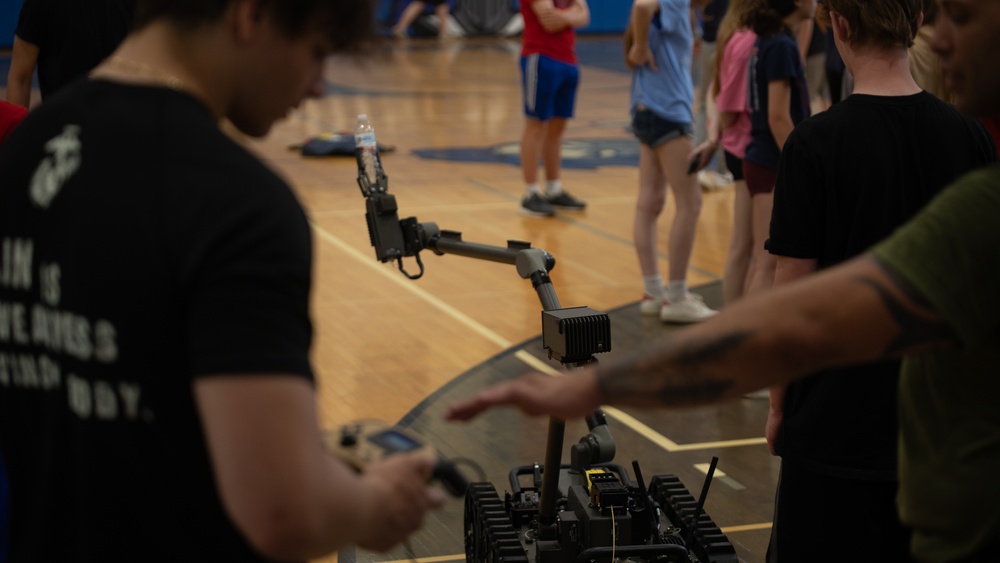 U.S. Marines with the Silent Drill Platoon and the Quantico Band interact with the students of Elwood.