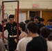 U.S. Marines with the Silent Drill Platoon and the Quantico Band interact with the students of Elwood.
