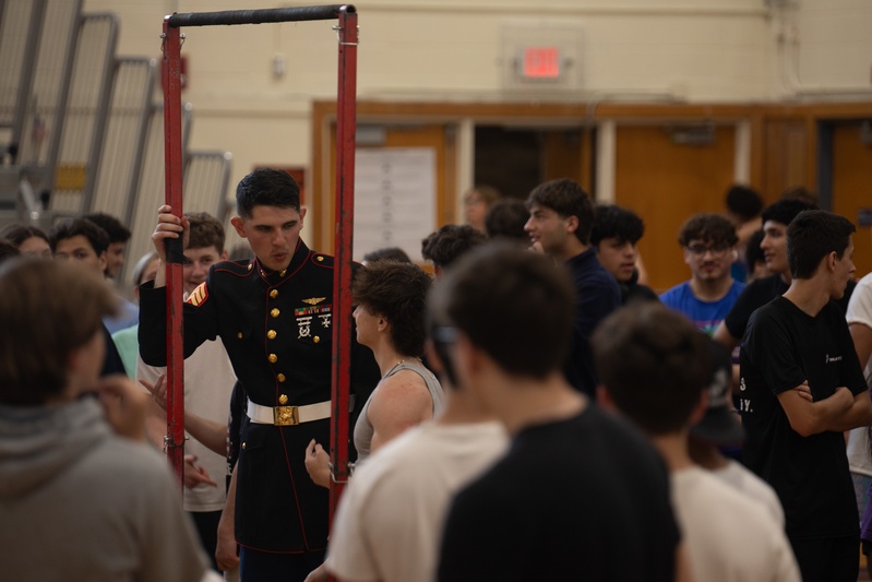 U.S. Marines with the Silent Drill Platoon and the Quantico Band interact with the students of Elwood.