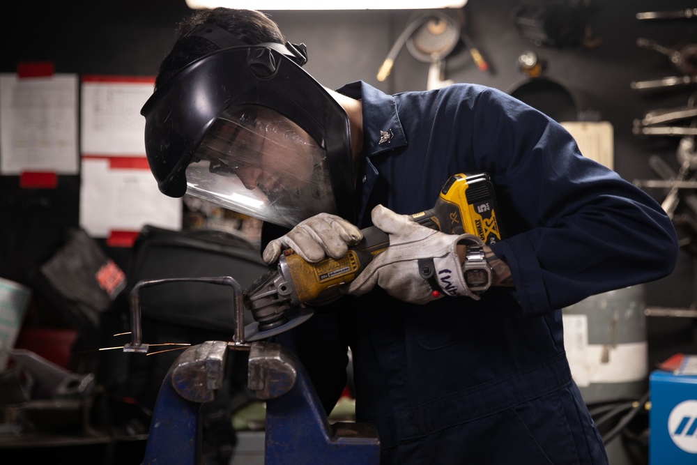 Sailor grinds down metal aboard Abraham Lincoln