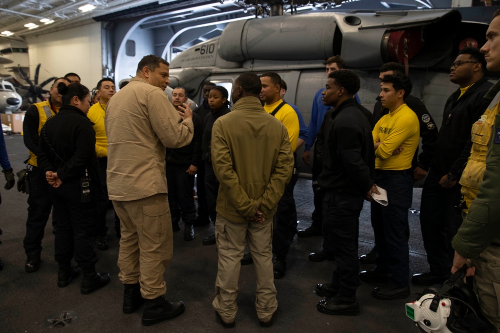 Rear Adm. Adan Cruz speaks to Sailors aboard Abraham Lincoln