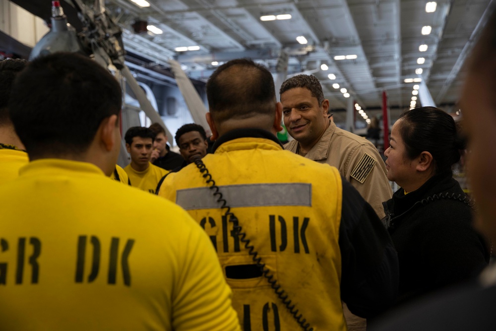 Rear Adm. Adan Cruz speaks to Sailors aboard Abraham Lincoln