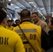 Rear Adm. Adan Cruz speaks to Sailors aboard Abraham Lincoln