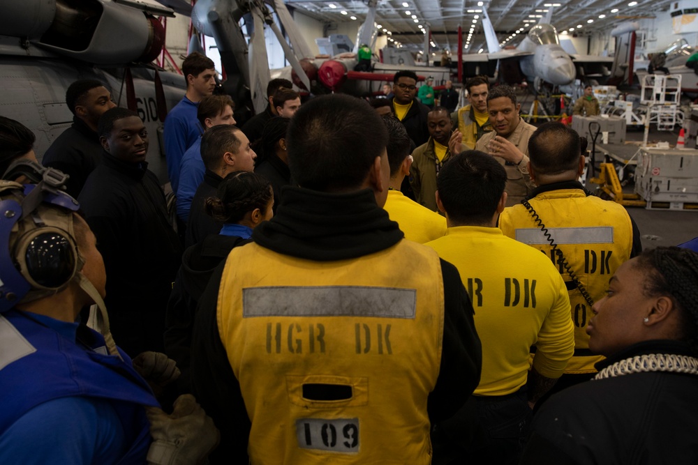 Rear Adm. Adan Cruz speaks to Sailors aboard Abraham Lincoln