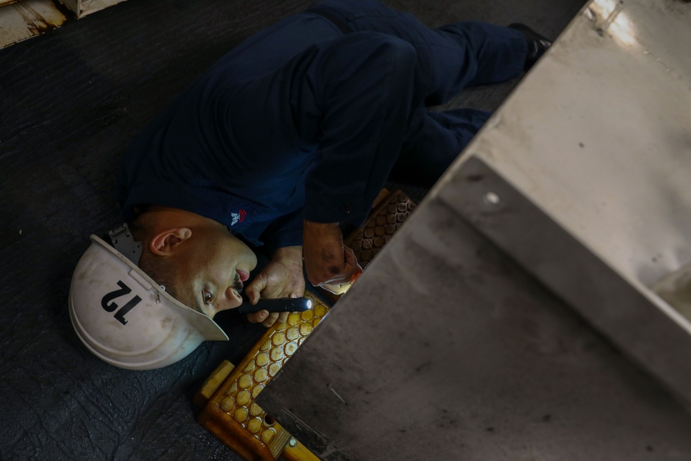 Sailor inspects fuel tank on Abraham Lincoln