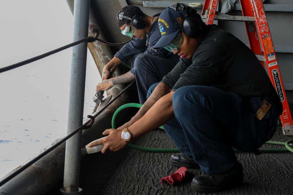 Sailors conduct maintenance on Abraham Lincoln