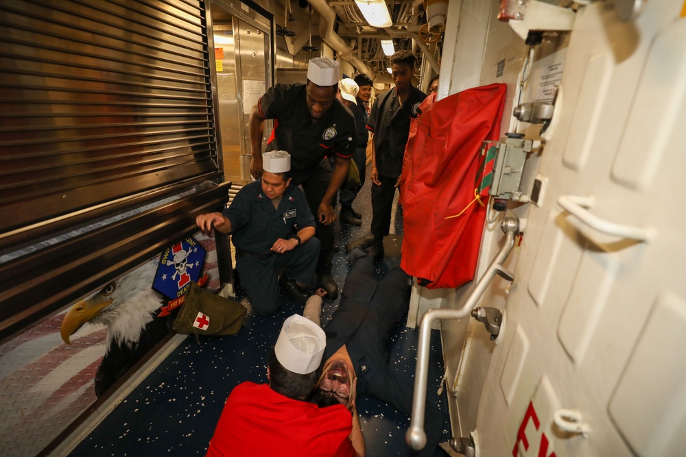 Sailors aboard the USS Howard conduct a medical emergency drill on the mess decks in the South China Sea