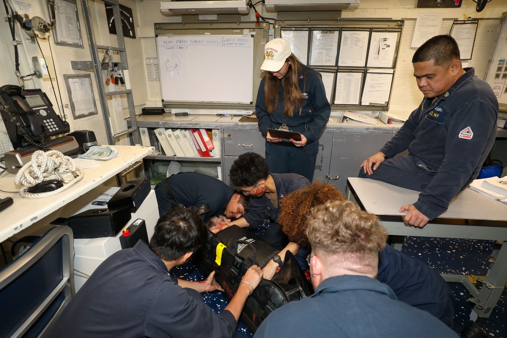 Sailors aboard the USS Howard conduct a medical emergency drill in the central control station in the South China Sea