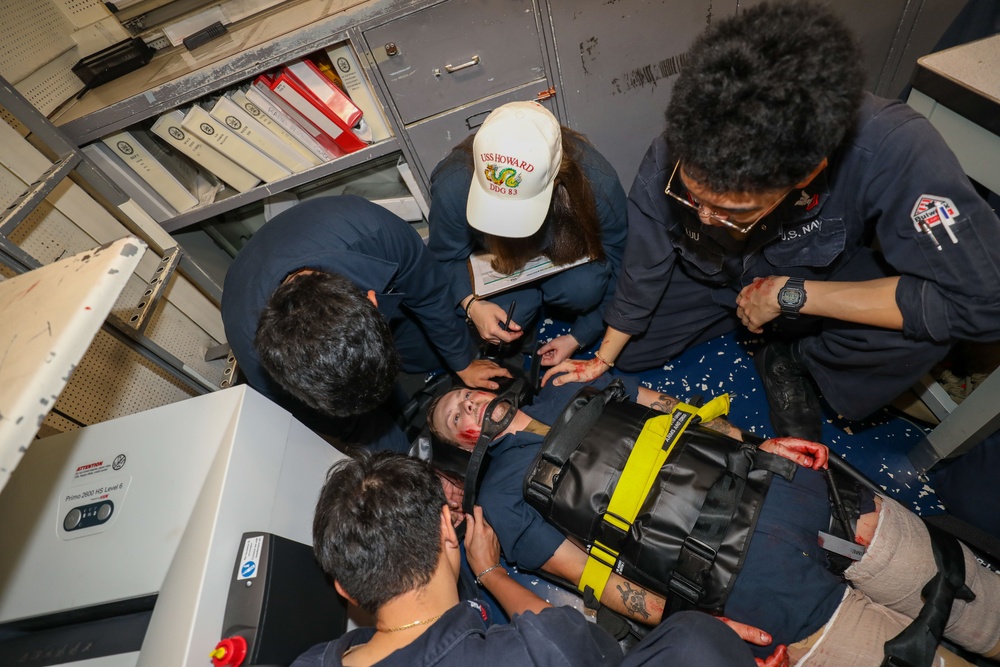 Sailors aboard the USS Howard conduct a medical emergency drill in the central control station in the South China Sea