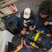 Sailors aboard the USS Howard conduct a medical emergency drill in the central control station in the South China Sea