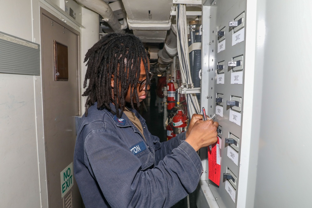Sailors aboard the USS Howard conduct routine maintenance in the North Pacific Ocean