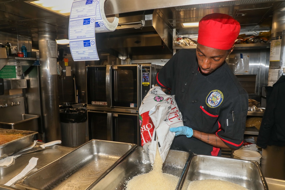 Sailors aboard the USS Howard prepare dinner in the North Pacific Ocean