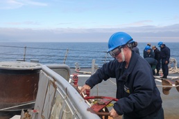 Sailors aboard the USS Howard conduct a sea and anchor detail in Yokosuka, Japan