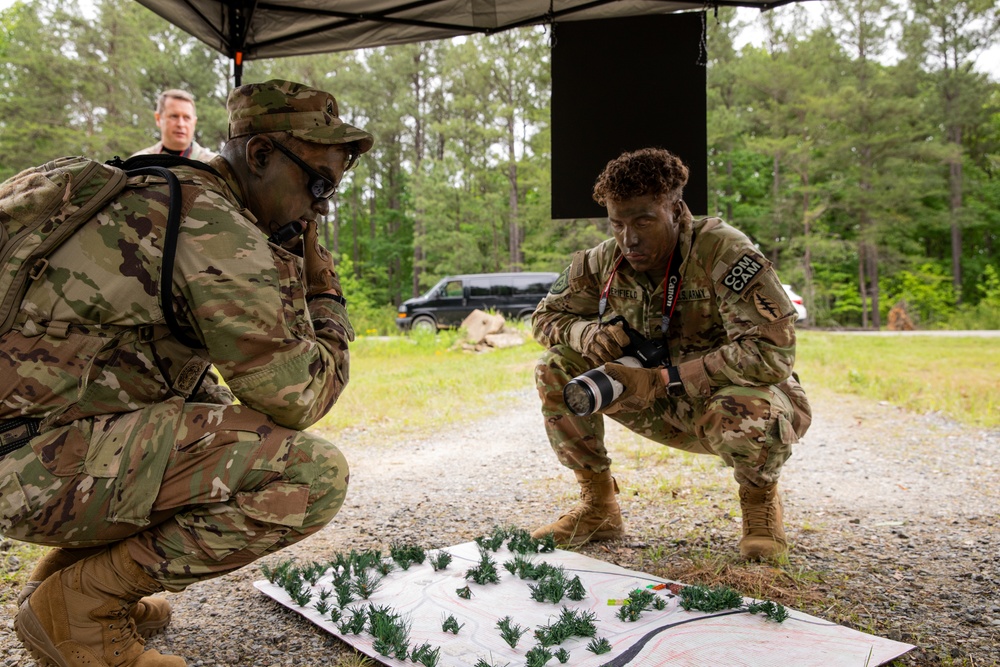 Participants of the 11th Annual Best Combat Camera Competition prepare to compete in an event.