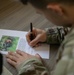 Participants of the 11th Annual Best Combat Camera Competition prepare to compete in an event.