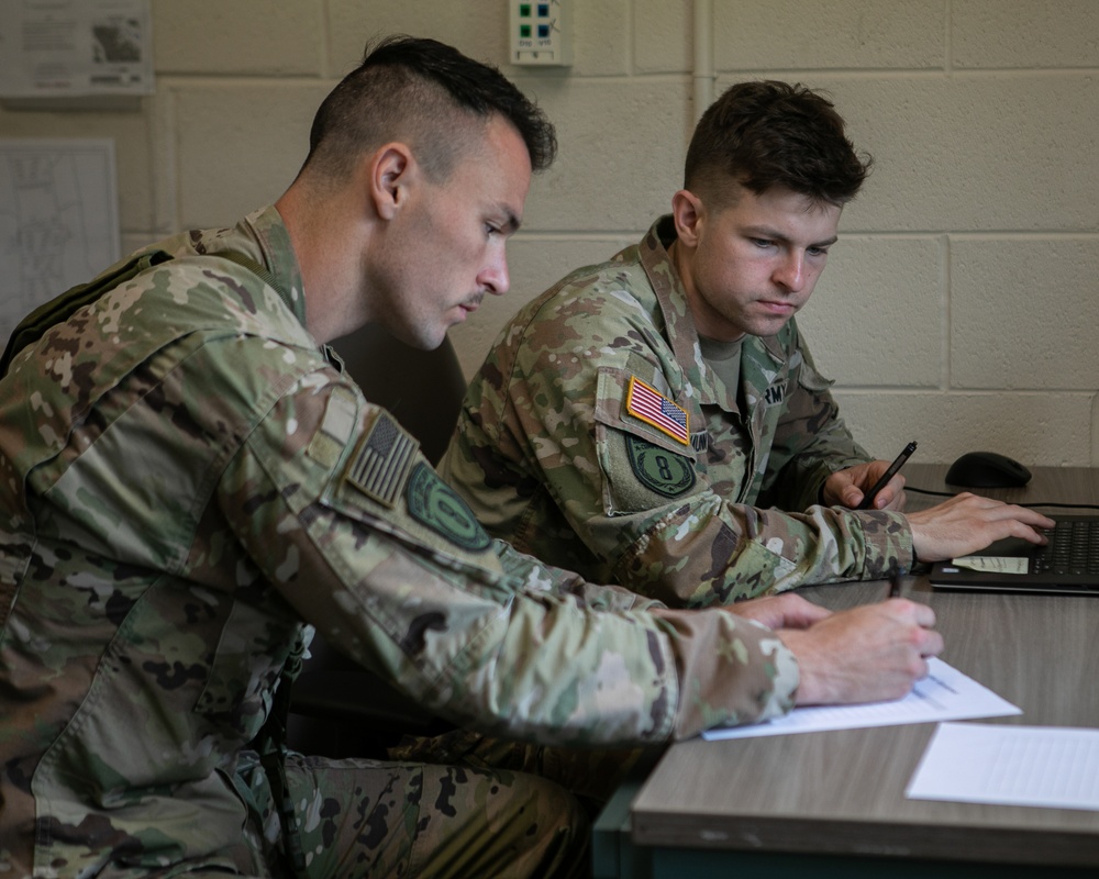 Participants of the 11th Annual Best Combat Camera Competition prepare to compete in an event.