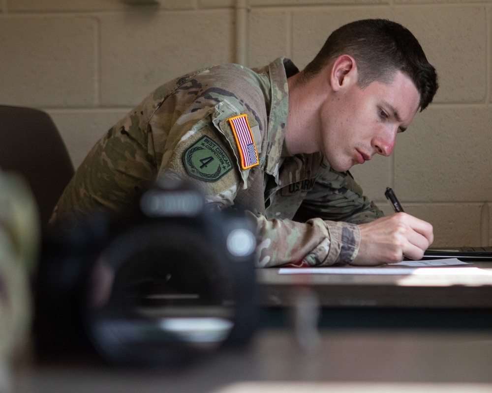 Participants of the 11th Annual Best Combat Camera Competition prepare to compete in an event.