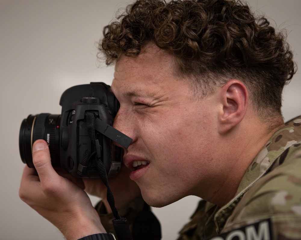 Participants of the 11th Annual Best Combat Camera Competition prepare to compete in an event.