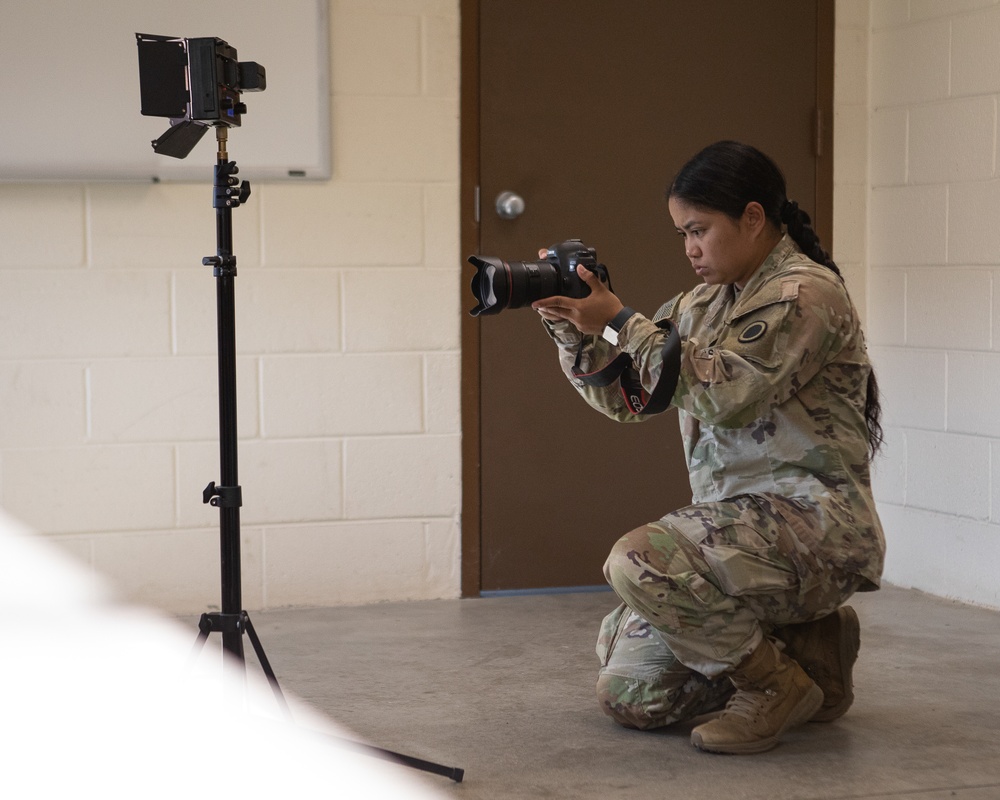 Participants of the 11th Annual Best Combat Camera Competition prepare to compete in an event.