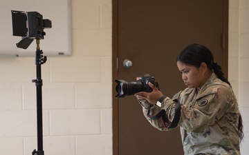 Participants of the 11th Annual Best Combat Camera Competition prepare to compete in an event.