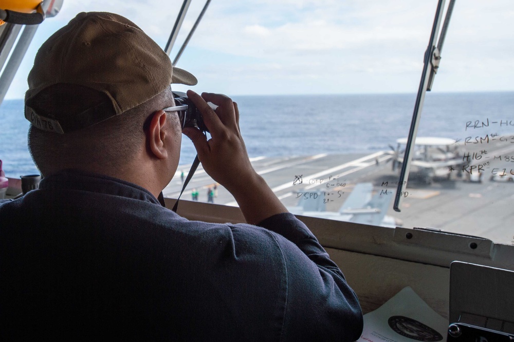 USS Ronald Reagan (CVN 76) Sailors stand watch in the pilot house