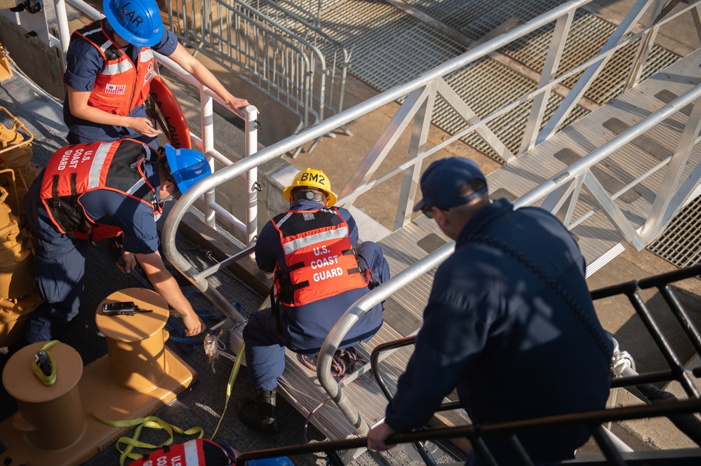 U.S. Coast Guardsmen attach brow to USCGC Calhoun